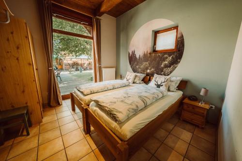 a bedroom with a bed in a room with a window at Ferienhof Holste GmbH in Walsrode
