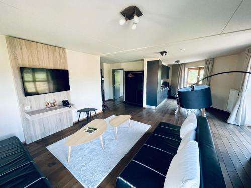 a living room with a couch and a table at La Merveilleuse by Infiniti hôtel in Dinant
