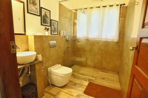 a bathroom with a toilet and a sink at Vala House in Cherai Beach