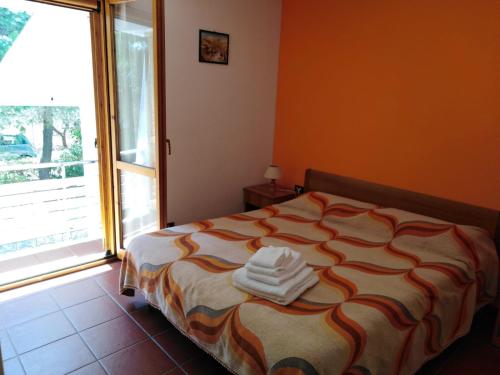 a bedroom with a bed with towels on it at Raggio Di Sole in Alberobello