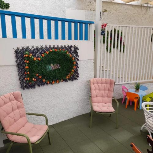 a patio with two chairs and a sign that says hello at Mediterrâneo Madeira in São Vicente