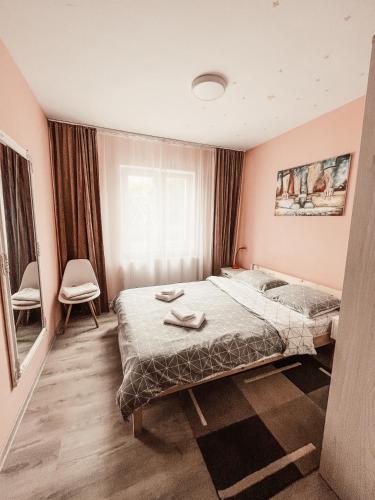 a bedroom with two beds and a window at Apartament One Divine - Zarnesti in Zărneşti