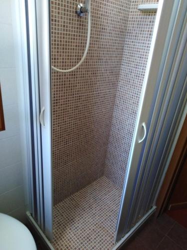 a shower with a glass door in a bathroom at Raggio Di Sole in Alberobello