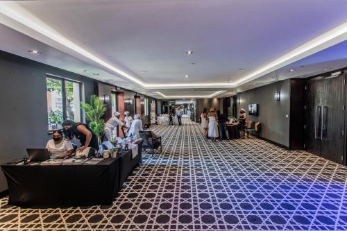 a group of people in a hotel lobby at The Capital Zimbali in Ballito