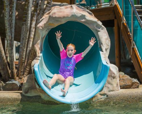 a young girl on a slide at a water park at BIG4 Adventure Whitsunday Resort in Airlie Beach