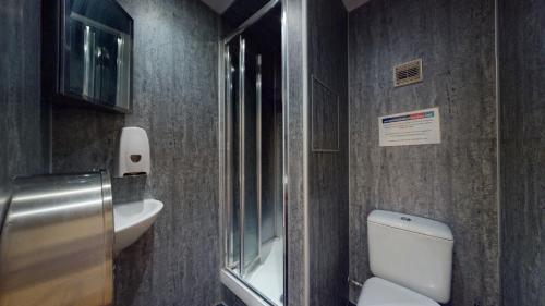 a bathroom with a toilet and a sink at 247London Studio Flats in London