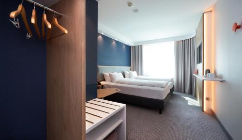 a hotel room with two beds and a window at Holiday Inn Express & Suites - Basel - Allschwil by IHG in Basel