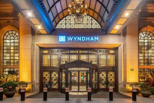 a building with a sign on the front of it at Wyndham Shanghai Hongqiao-Near NECC in Shanghai