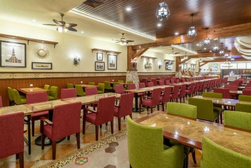 a restaurant with wooden tables and chairs in a room at Wyndham Shanghai Hongqiao-Near NECC in Shanghai