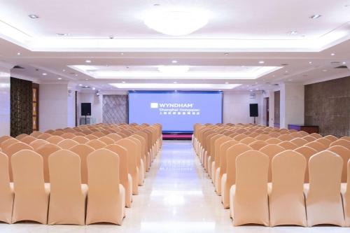an empty room with chairs and a projection screen at Wyndham Shanghai Hongqiao-Near NECC in Shanghai