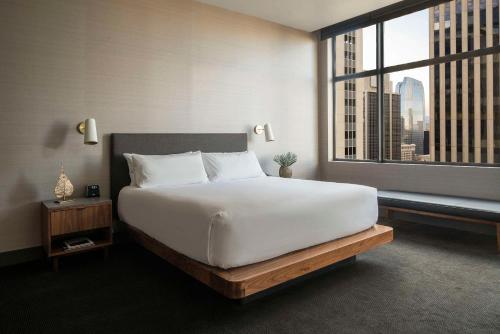 a bedroom with a large bed and a large window at Grand Hyatt Denver in Denver
