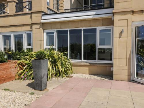 a building with windows and plants in front of it at The Studio in Weston-super-Mare