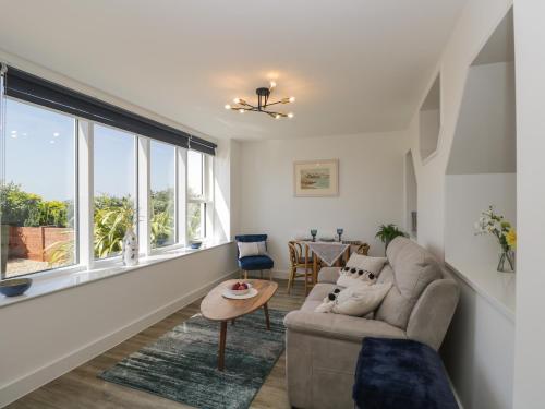 a living room with a couch and a table at The Studio in Weston-super-Mare