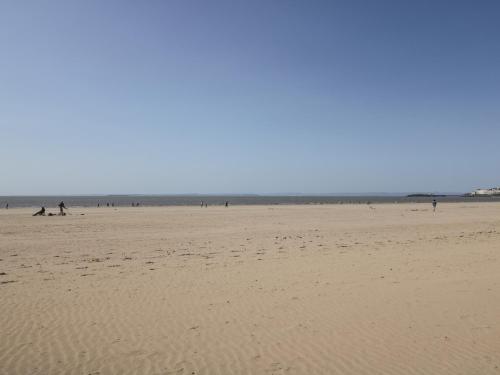 a beach with people and a group of people on it at The Studio in Weston-super-Mare