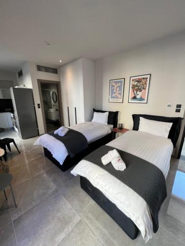 a hotel room with two beds in it at Pearl Apartel in Volos