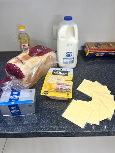 a counter with some food and a bottle of milk at MataMata in Matamata