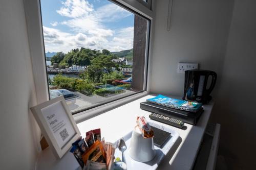 a kitchen counter with a window looking out at the water at Coolin View in Portree