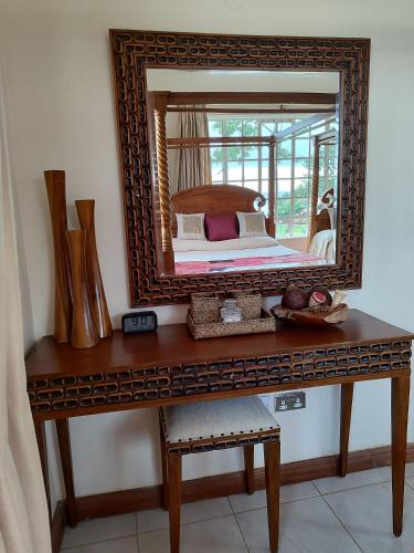 a mirror on top of a wooden table at Kisuri Resort in Sena