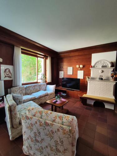 a living room with a couch and a table at Al Sole Hotel Ristorante dal 1870 in Pieve di Cadore