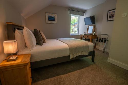 a bedroom with a large bed and a window at Coolin View in Portree