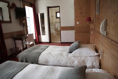 Ένα ή περισσότερα κρεβάτια σε δωμάτιο στο Hôtel Val d'Este