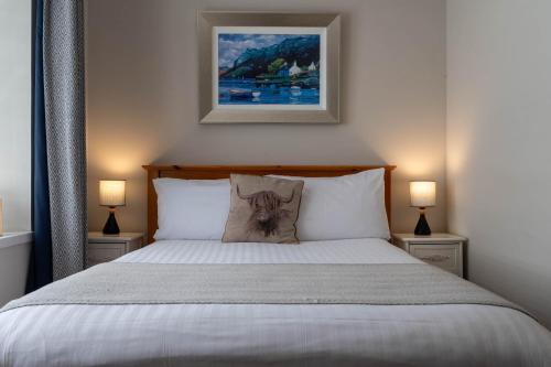 a bedroom with a bed with a dog pillow on it at Coolin View in Portree