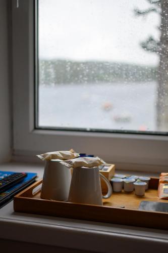 a tray with cups on a table next to a window at Coolin View in Portree