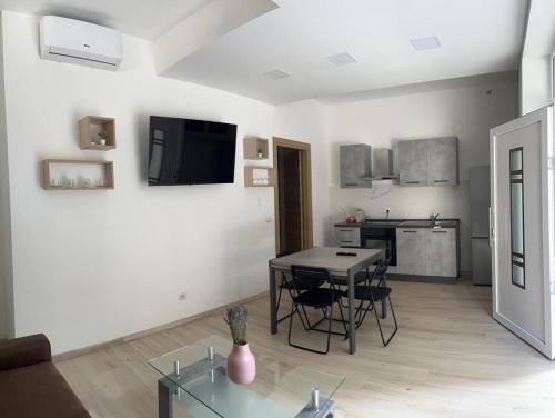 a living room with a table and a kitchen at Villa Milano Apt. n. 1 in Milan