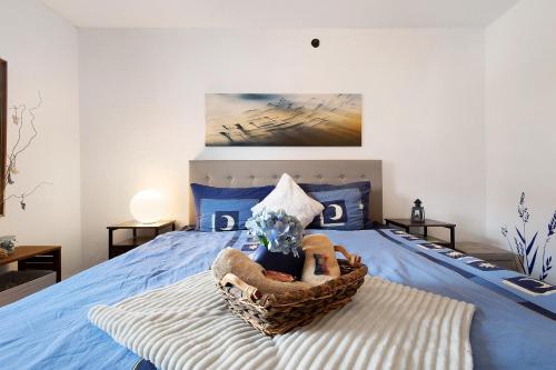ein Schlafzimmer mit einem blauen Bett und einem Korb darauf in der Unterkunft Lindenhardt in Creußen