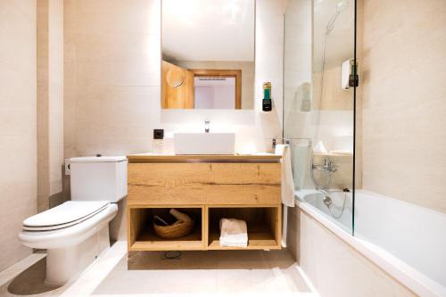 a bathroom with a toilet and a sink and a shower at Apartaments SB Corona Tortosa in Tortosa