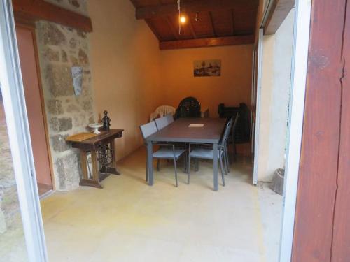 a dining room with a wooden table and chairs at Maison de vacances en Ardèche in Pailharès