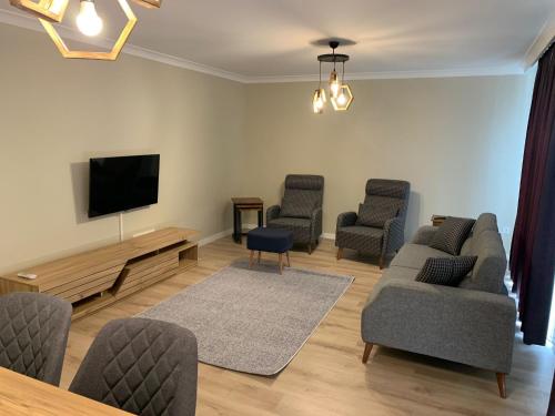 a living room with chairs and a flat screen tv at AHG Atlas Apartments in Istanbul