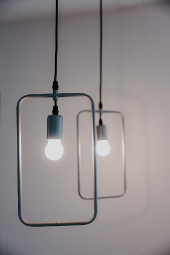 two lights hanging from the ceiling in a room at Pearl Apartel in Volos