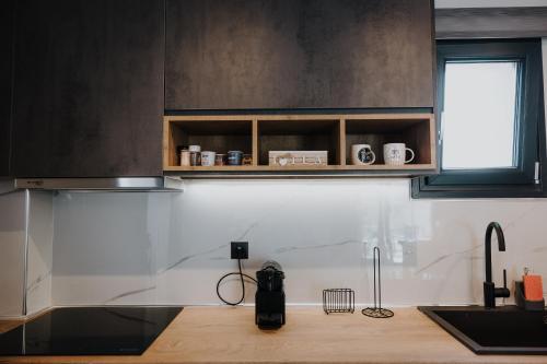 a kitchen with a sink and a counter top at Pearl Apartel in Volos