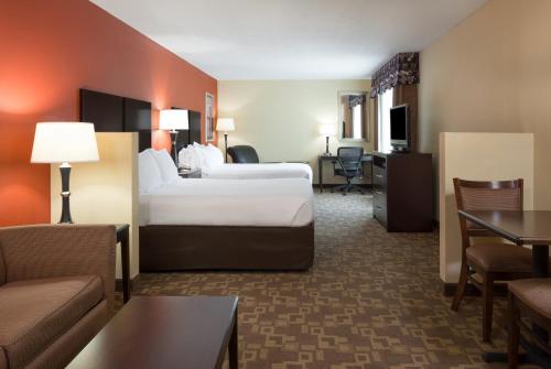 a hotel room with a bed and a couch at Holiday Inn Express & Suites Lexington Downtown Area-Keeneland by IHG in Lexington