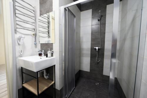 a bathroom with a sink and a shower at Hotel Golden lemon Готель Золотий лимон in Lviv