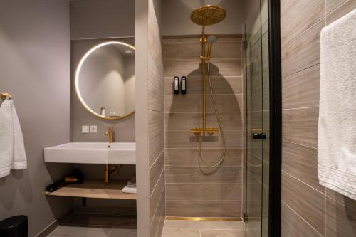 a bathroom with a shower and a sink at Hotel Hvide Falk in Ilulissat