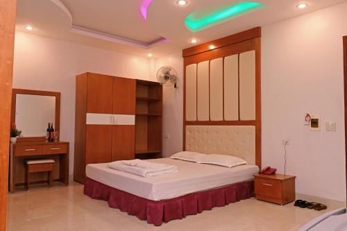 a bedroom with a bed and a sink and a mirror at Khách sạn Hoàng Hà River Town in Yên Bái