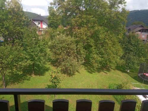 a balcony with a view of a yard with trees at Apartman 2 RIBIČ in Ogulin
