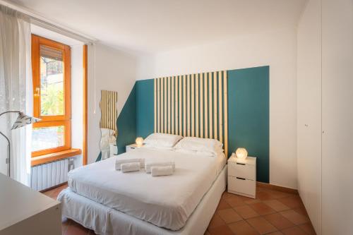 a bedroom with a large white bed and a window at Maison Desiderio in Sorrento
