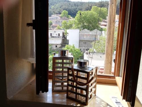 a window with a view of a city at Guesthouse Axieros in Samothraki