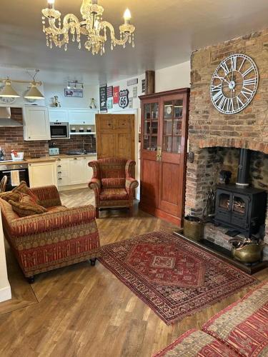 a living room with a couch and a fireplace at The Corner House Belford in Belford