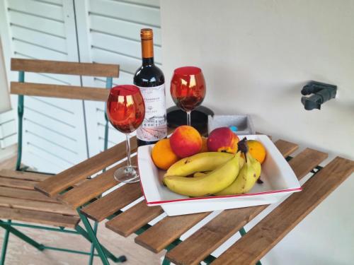 a plate of fruit and two glasses of wine at Phivos Home & Garden in Messini