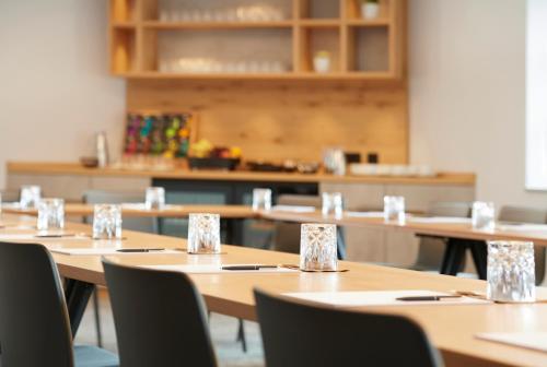 a row of tables and chairs in a room at Hotel Hanauerhof in Appenweier