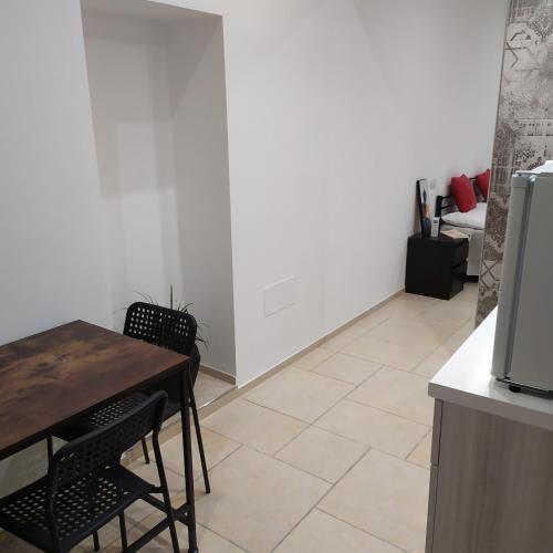 a kitchen with a table and chairs in a room at STRADONE 132 in Gravina in Puglia