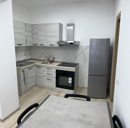 a kitchen with a table and a refrigerator at Villa Milano Apt. n. 3 in Milan