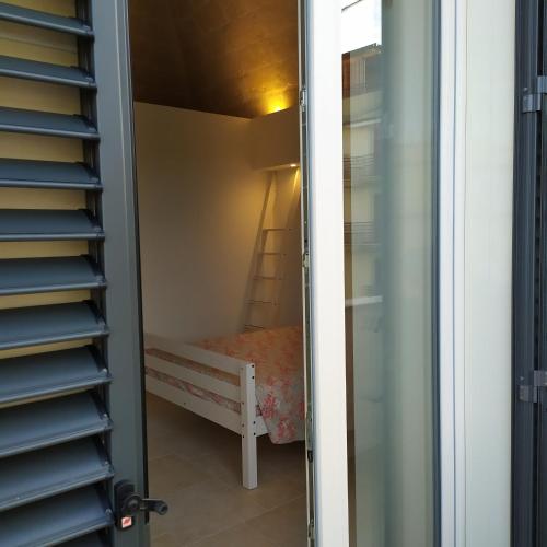 a small room with a bed in a closet at STRADONE 132 in Gravina in Puglia