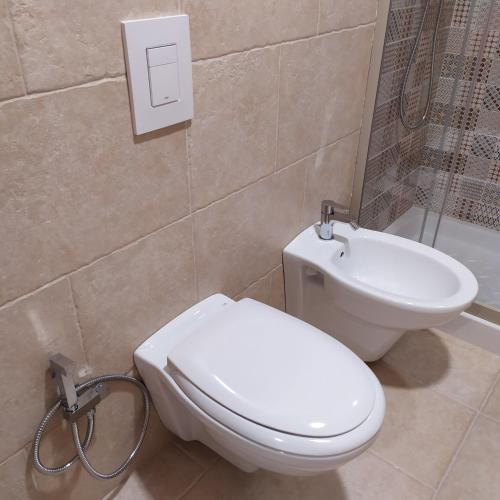 a bathroom with a toilet and a sink at STRADONE 132 in Gravina in Puglia