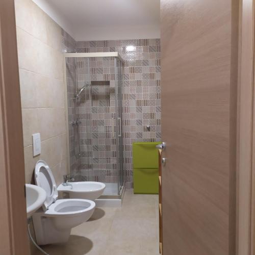 a bathroom with a toilet and a sink and a shower at STRADONE 132 in Gravina in Puglia