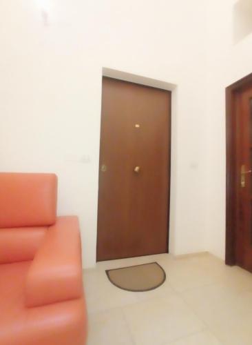 a room with a door and a couch and a door at STRADONE 132 in Gravina in Puglia